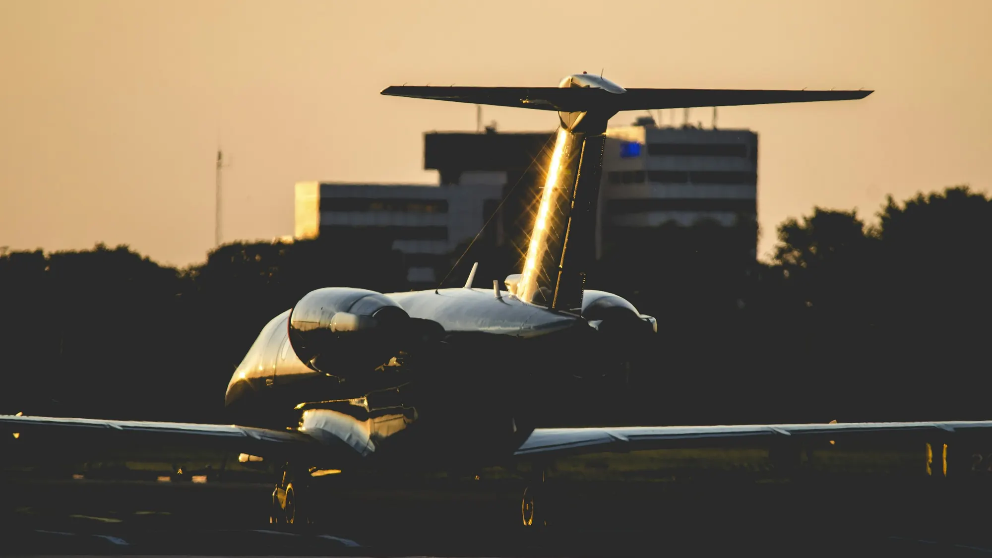 Business jet on a ramp at night under floodlights