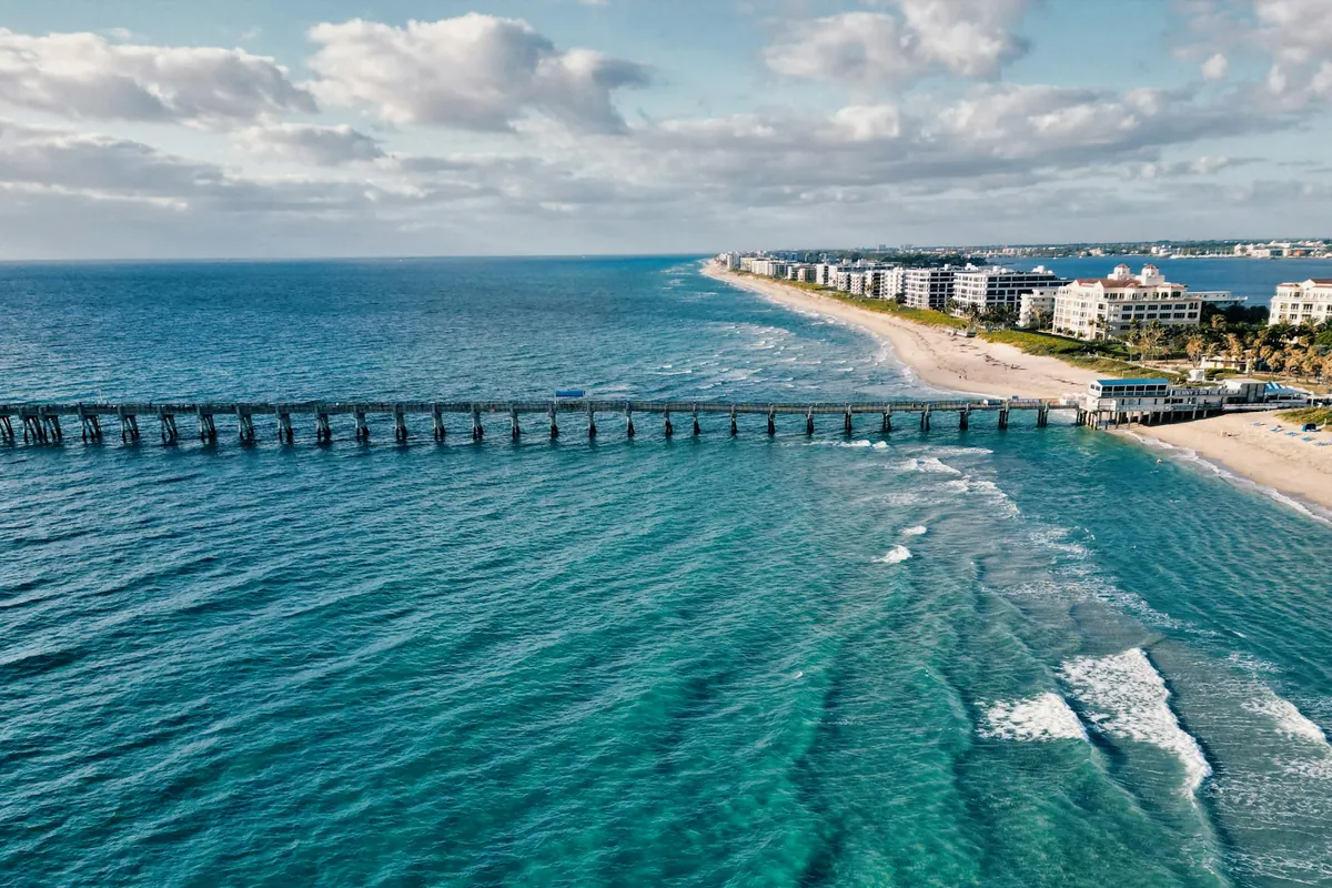 Aerial view of the Palm Beach coastline and a fishing pier